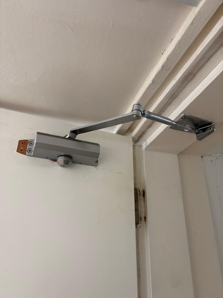 fire door closing mechanism for hmo compliance